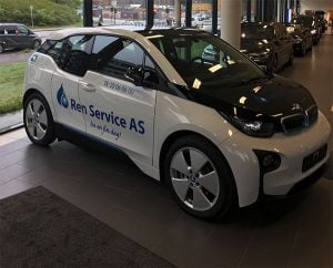 Ren Service AS firmabil parkert innendørs med store vinduer bak.